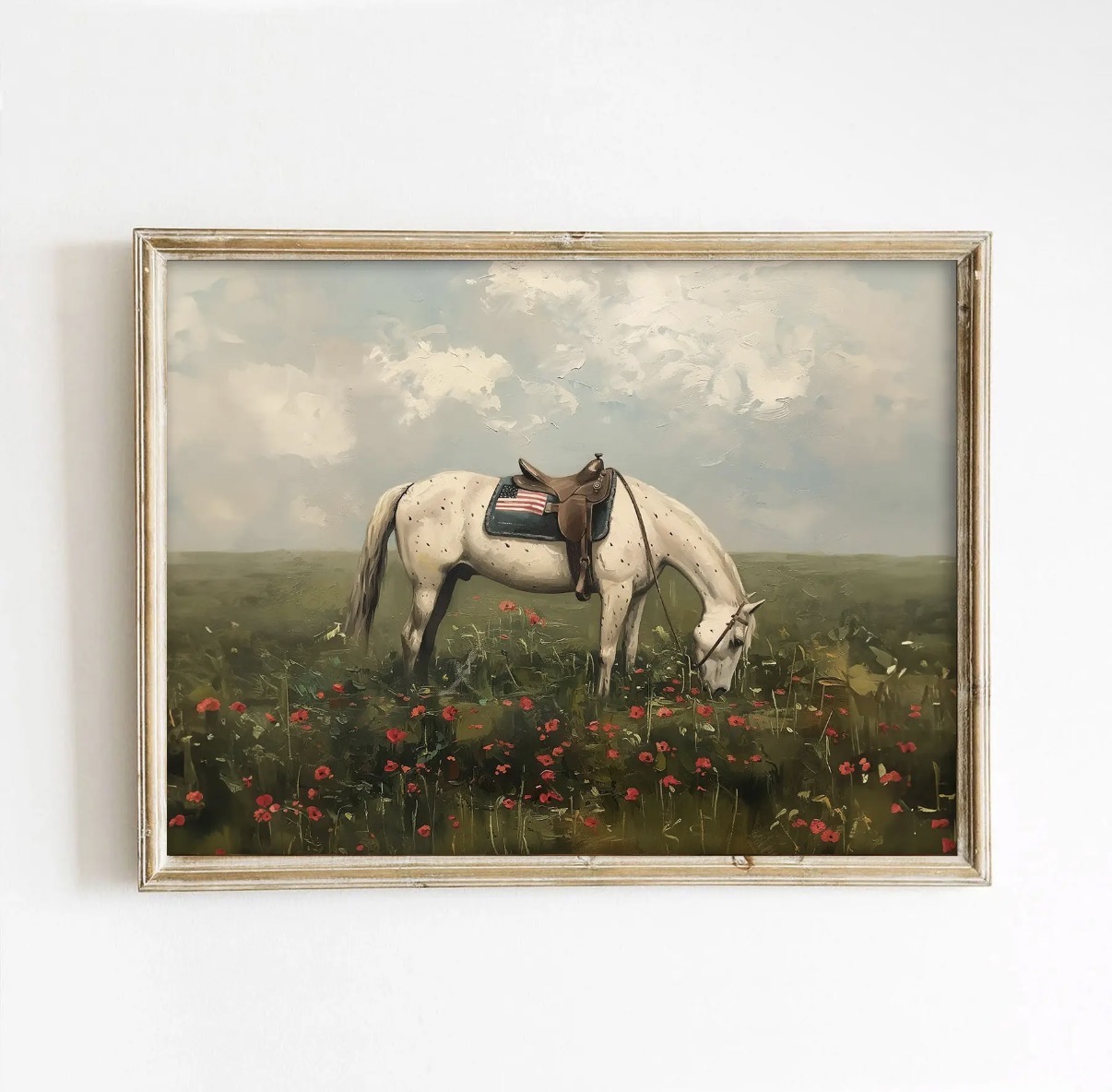 Art print of a spotted saddle horse with an American flag saddle blanket grazing among red poppies, shown in a gold frame