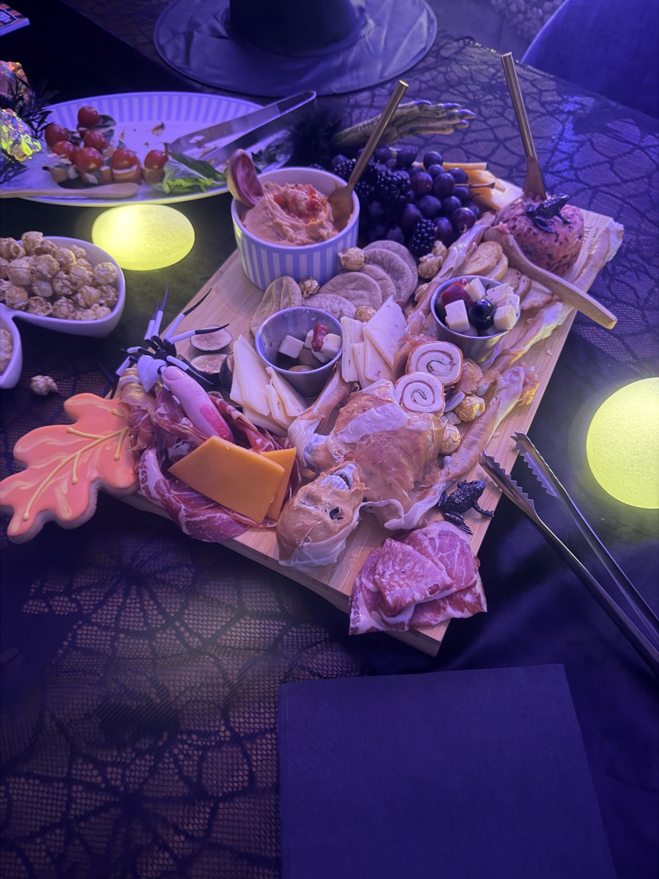 Ashley’s Halloween party spread with cheeses, treats and glowing lights