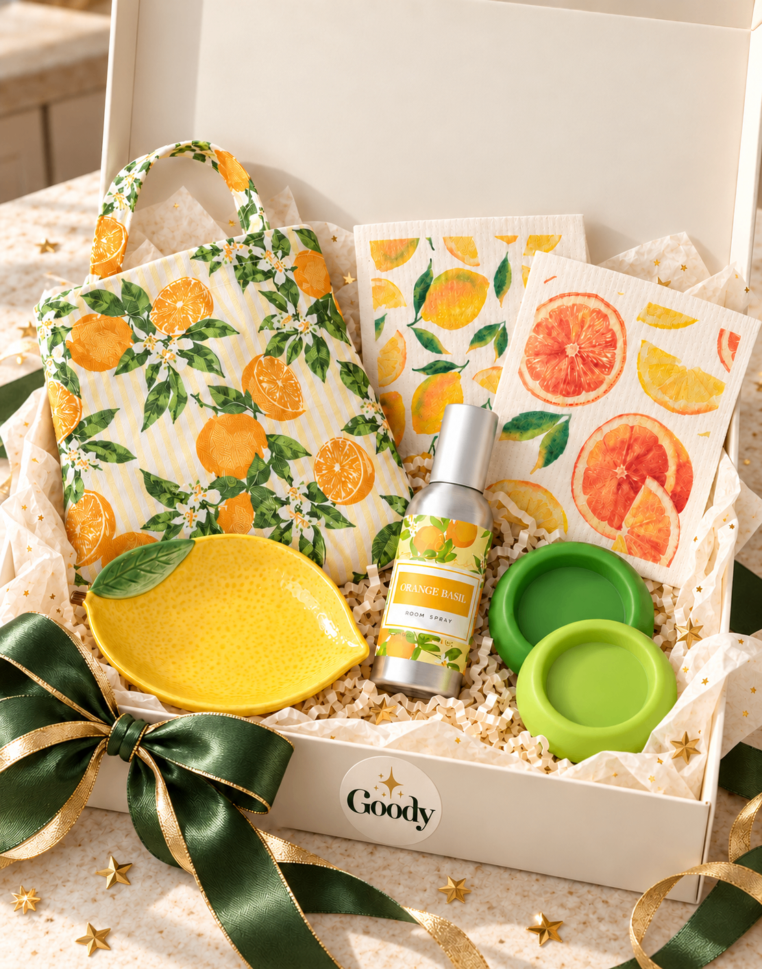 The Fresh Kitchen Edit in a Goody box: orange blossom apron, citrus dishcloths, Orange Basil room spray, lemon dish and green citrus savers
