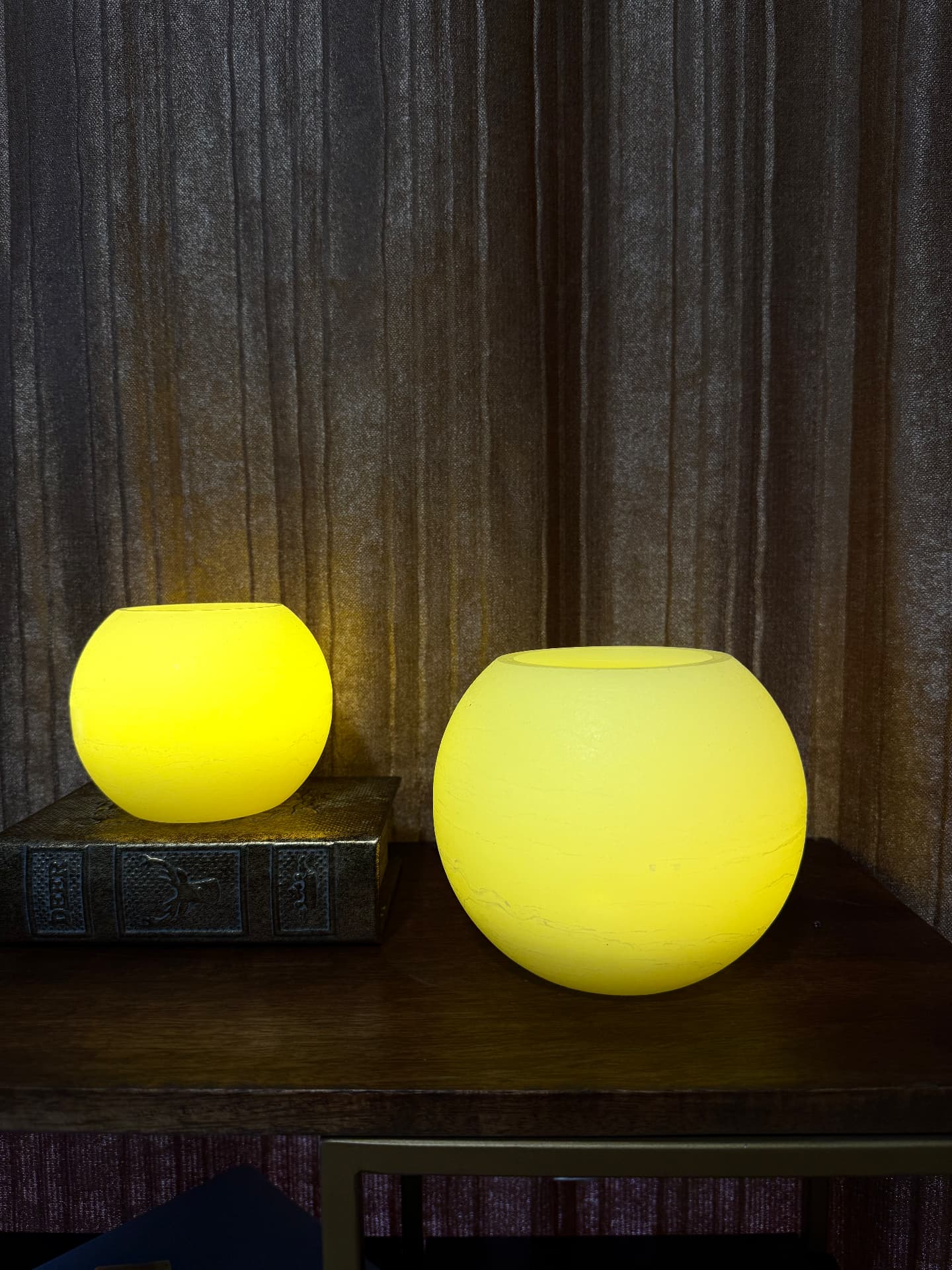 Small and medium LED sphere candles glowing on a console, sold separately