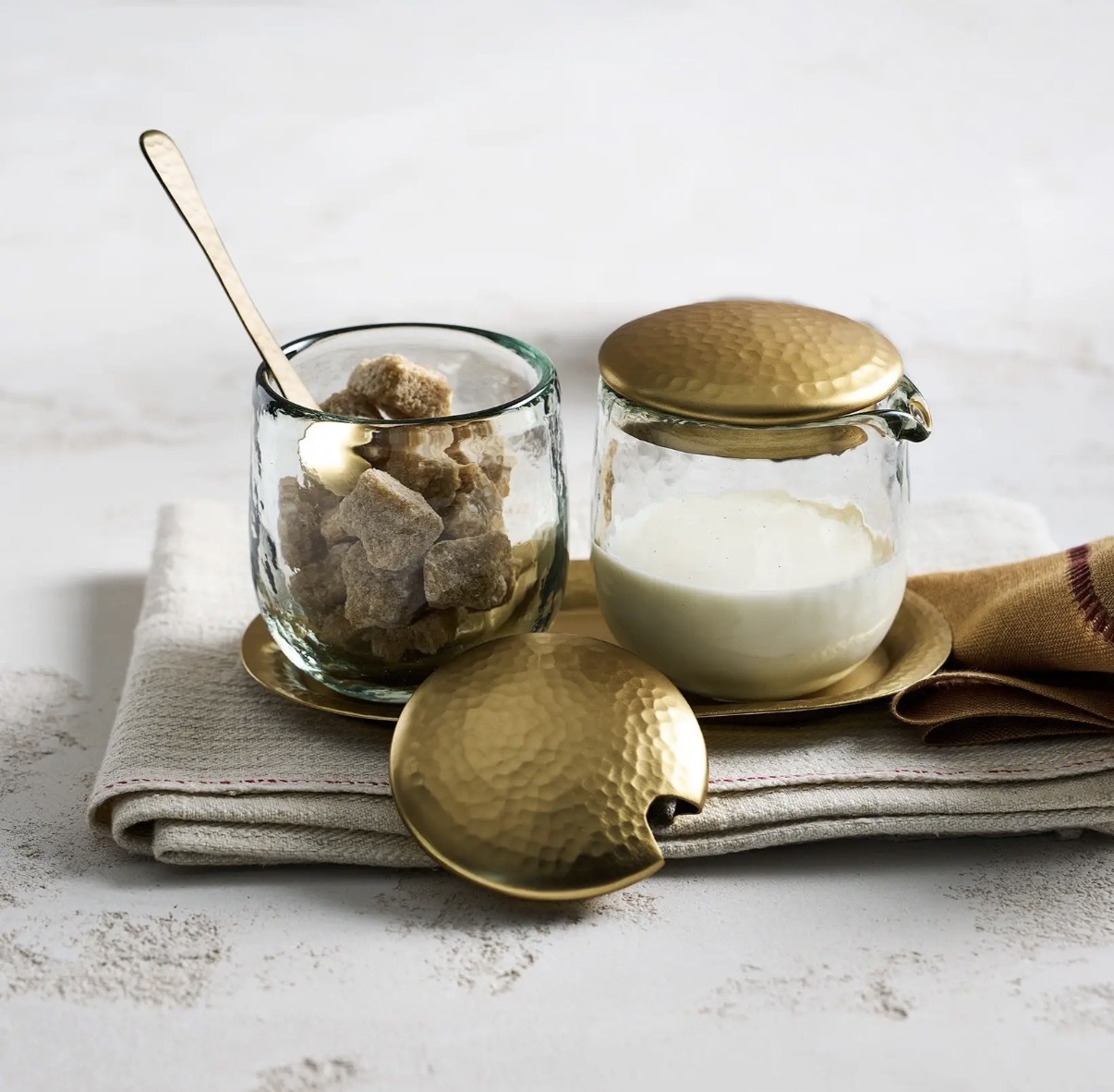 Pebbled glass sugar and creamer set with brass details