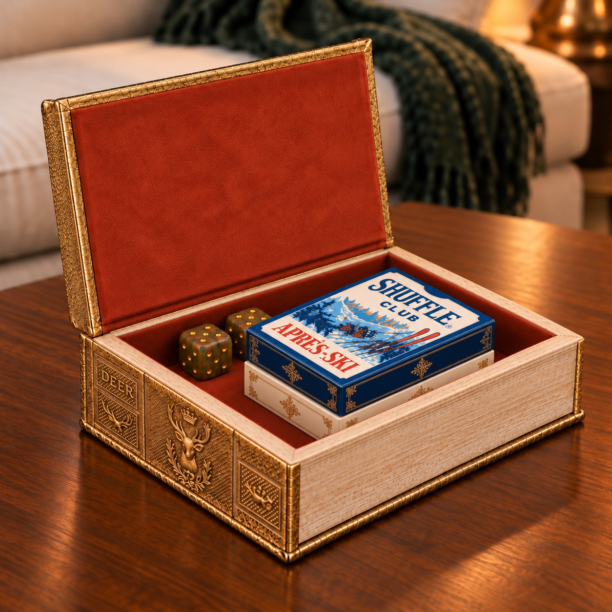Styled mockup of the open gold deer book box holding stacked card decks and mineral dice