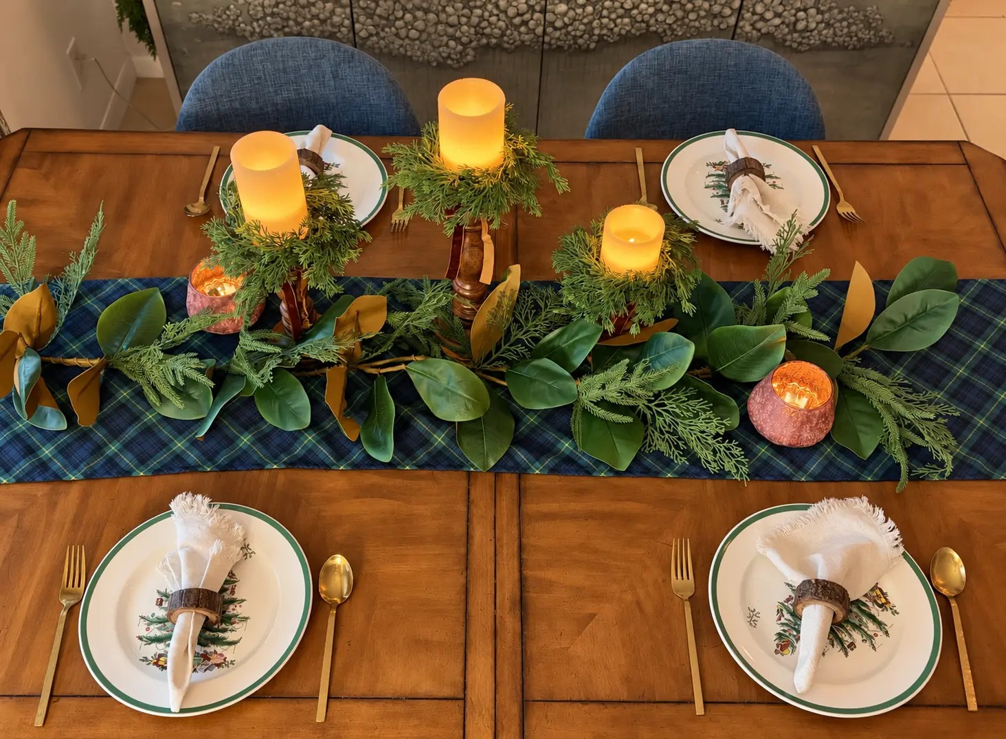 The full Winter Table Edit from above: tartan runner, garland, candle trio and four place settings